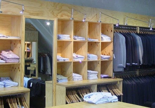 colored clothes on a plywood shelves department store